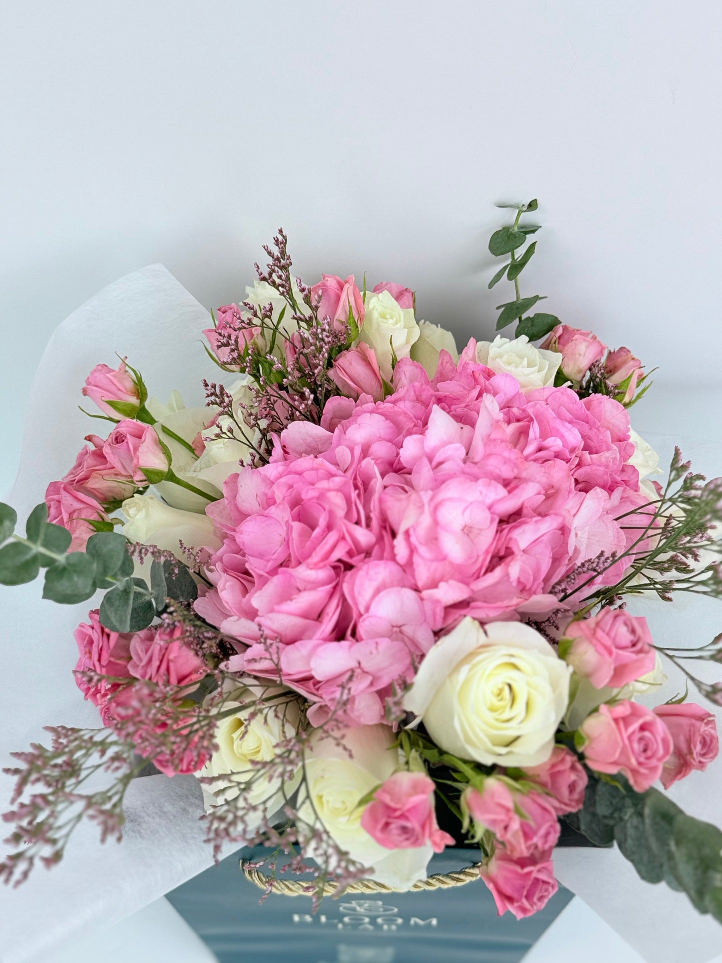 Pink hydrangea with white and blush roses in luxury Bag – online flower delivery