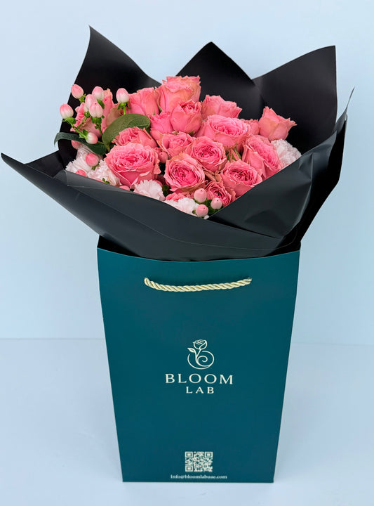 Pink roses and carnations wrapped in black paper – luxury flower bouquet Flowers UAE