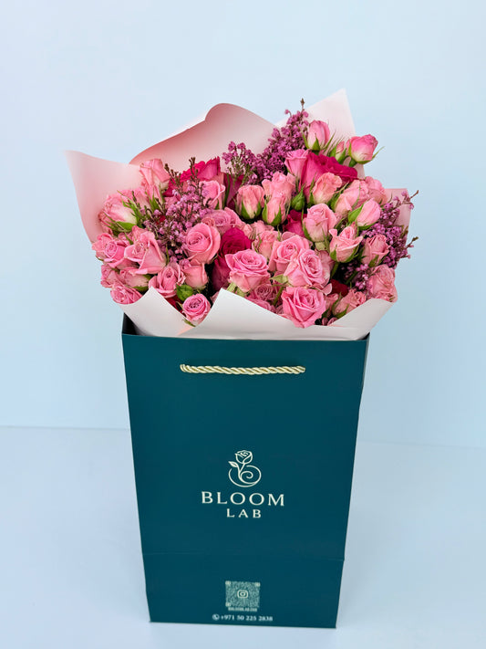 Luxury bouquet of pink roses with fillers wrapped in blush paper – online flower delivery Dubai UAE