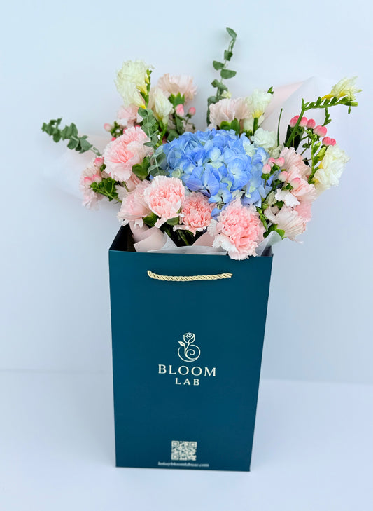 Blue hydrangea with pink carnations, white roses, and berries – Flowers in DUbai
