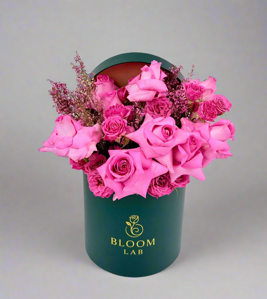 Elegant pink roses arranged in a luxury dark green Bloom Lab box – perfect for same-day flower delivery in Dubai.